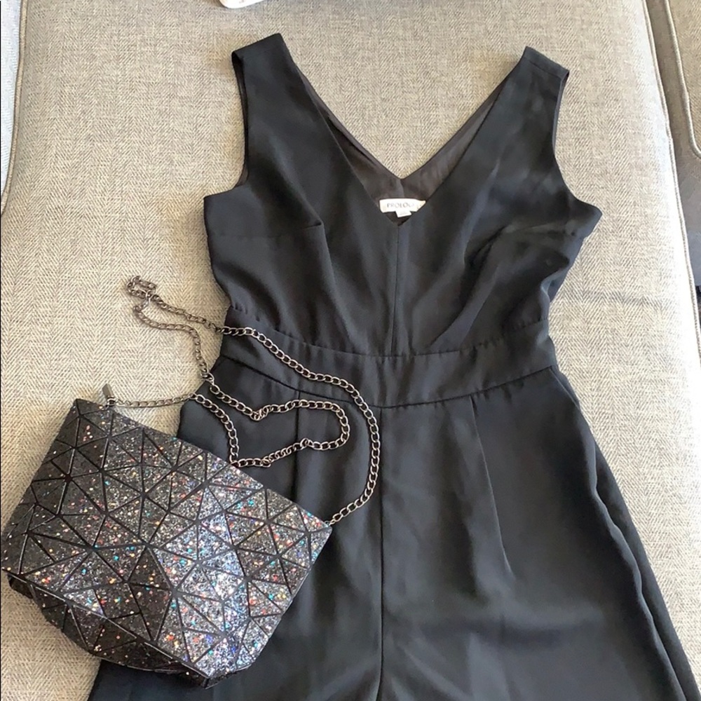 Black jumpsuit and geometric purse